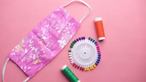 pink floral face mask with sewing supplies