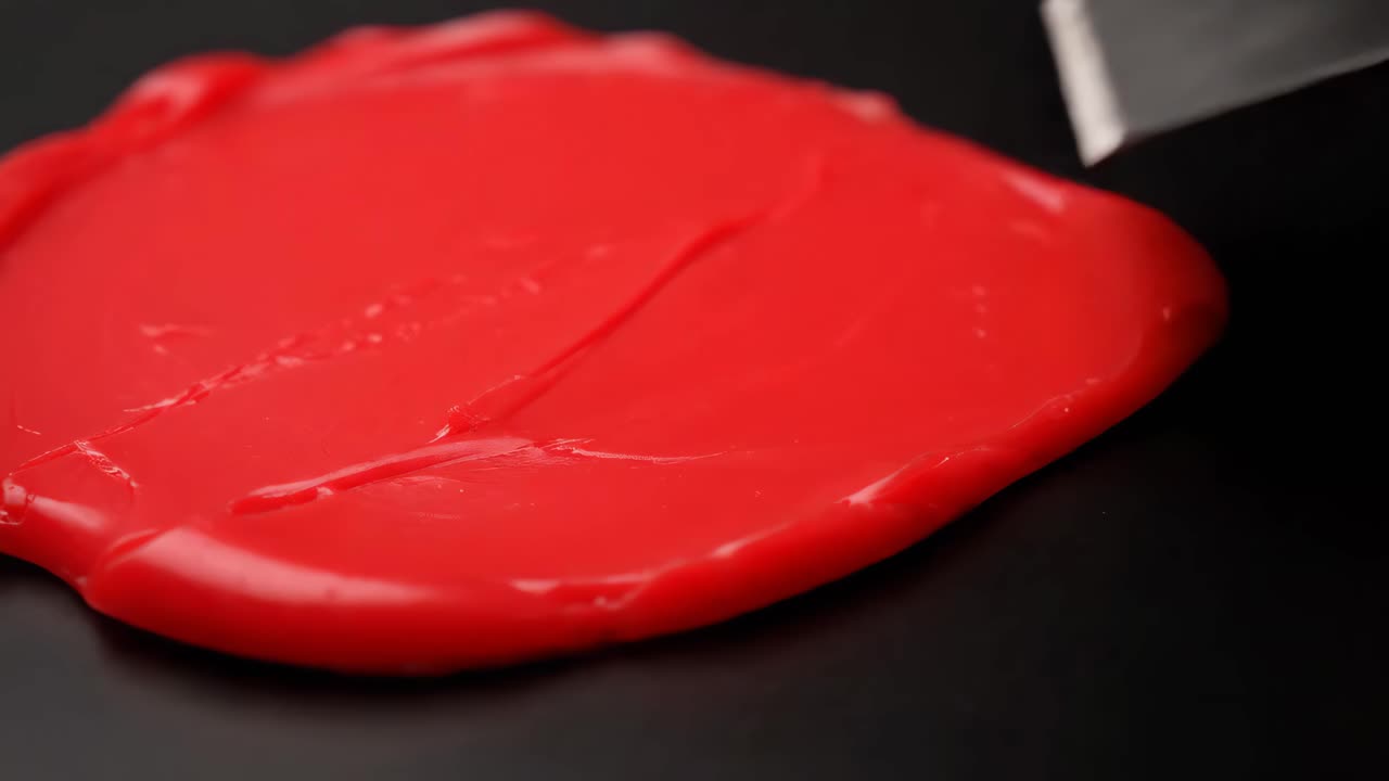 Red Paint on Black Surface