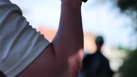 individual drinking from a large cup outdoors