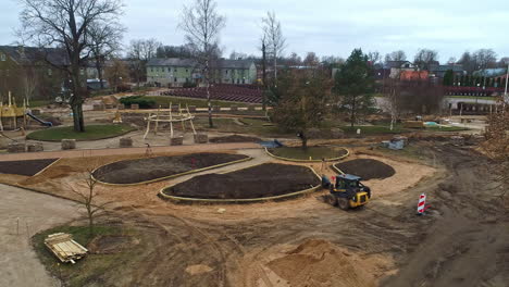 Aerial-of-a-under-construction-site-with-an-excavator-and-material-around-the-site