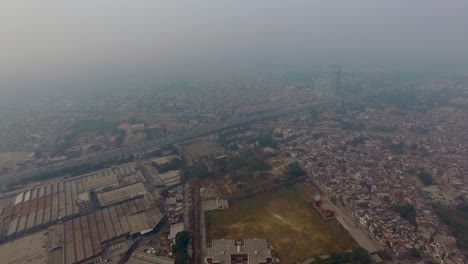 bombay, india, aerial flight of the city, a big highways and a bridge with traffic, foggy weather