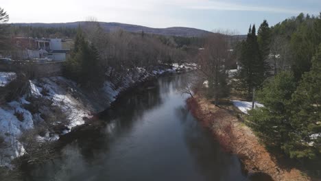 aerial of river in snowy forest white landscape in saint come quebec canada travel destination