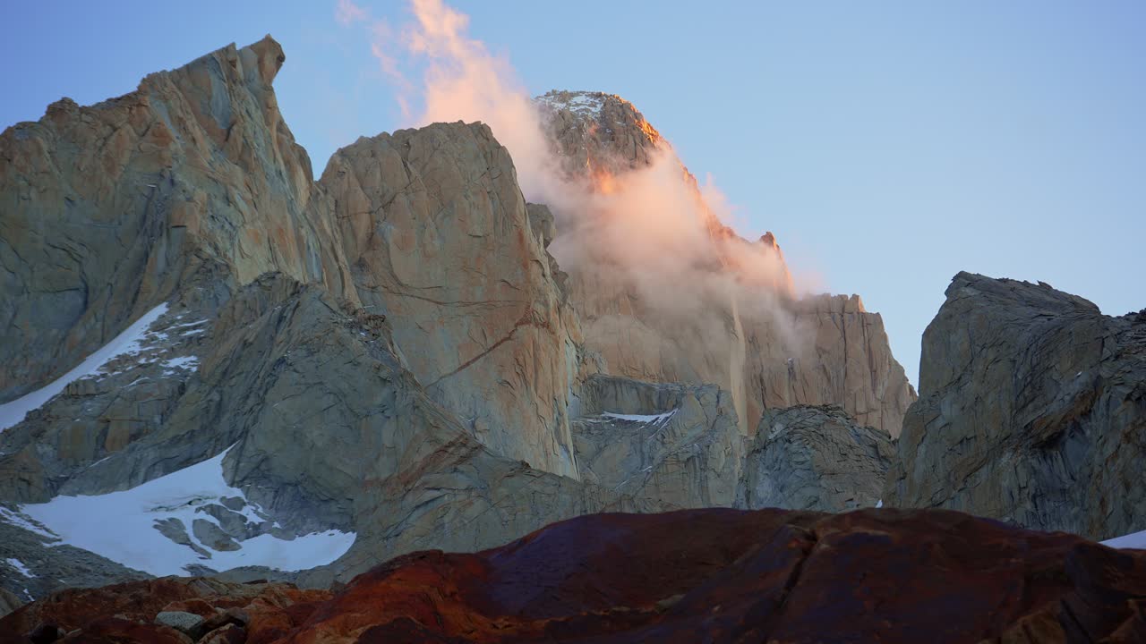 Atmospheric video capturing dramatic clouds passing over Mount Fitz Roy and Guillaumet with sunset light. Los Glaciares National Park, Argentina