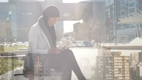 animation of asian woman in hijab using tablet over cityscape