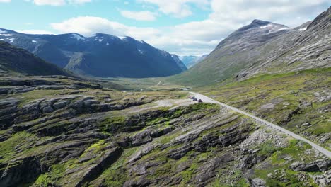 Reinheimen-National-Park,-cars-have-a-break-at-parking-lot-near-Trollstigen-in-Norway---Aerial