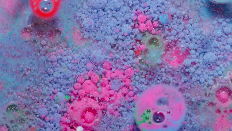 Top-view-movement-of-blue-pink-oil-ink-drops-bubbles,-multicolored-artistic-paint-surface-background