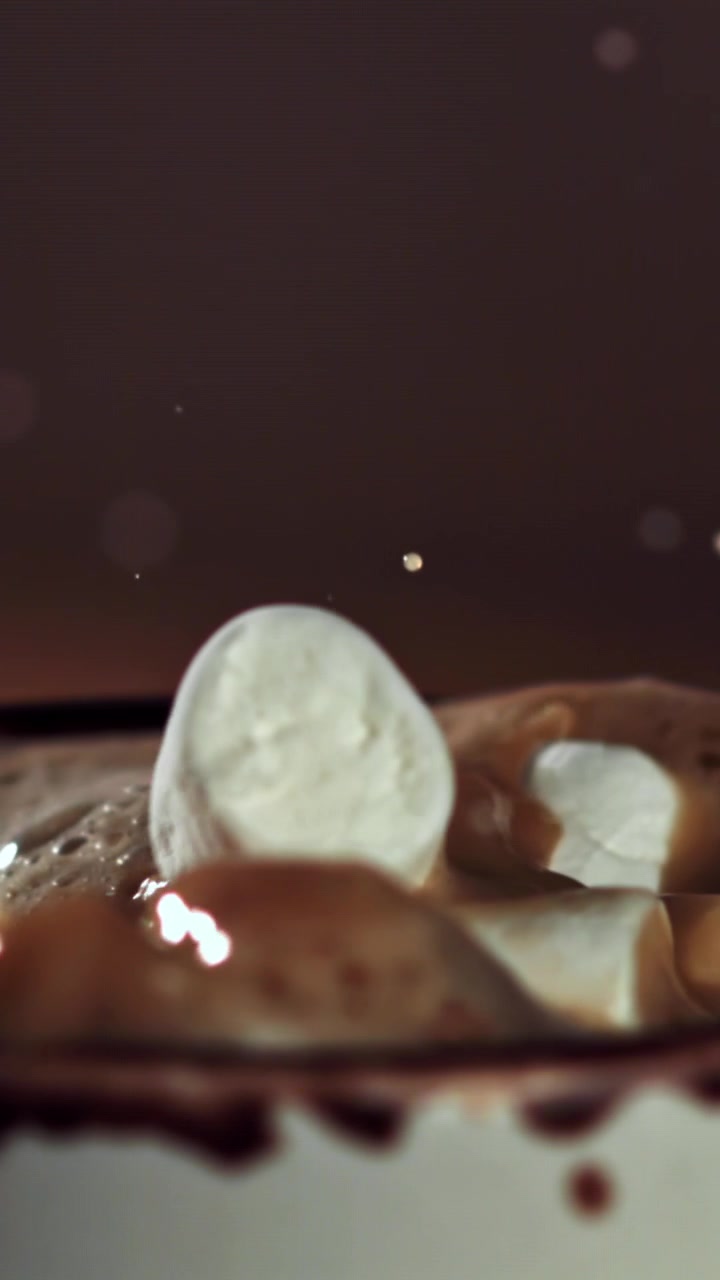 Marshmallow che si tuffano in una tazza di cioccolata calda al rallentatore