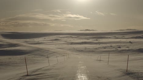 Leere-Straße-In-Einem-Schneesturm-Bei-Einem-Sonnenuntergang-Im-Winter-In-Skandinavien