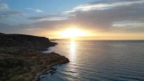 An-enchanting-Mediterranean-sunset-casts-a-radiant-glow-over-the-tranquil-waters-of-the-sea,-painting-the-horizon-with-brilliance