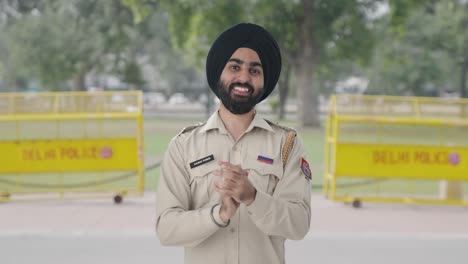 happy sikh indian police man clapping and appreciating