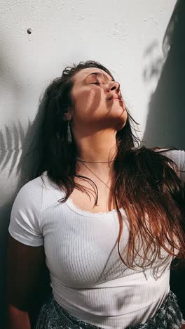 woman relaxing under tree shadow