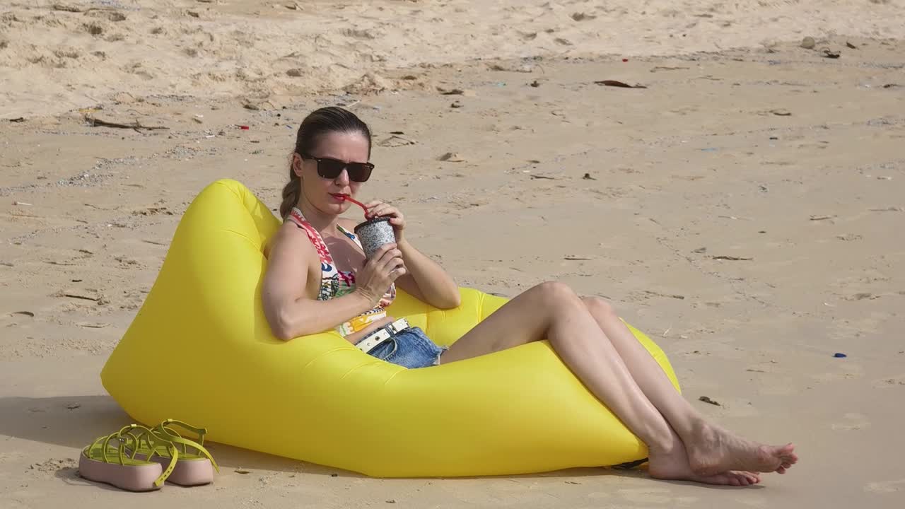 Woman Relaxing on a Beach Lounger