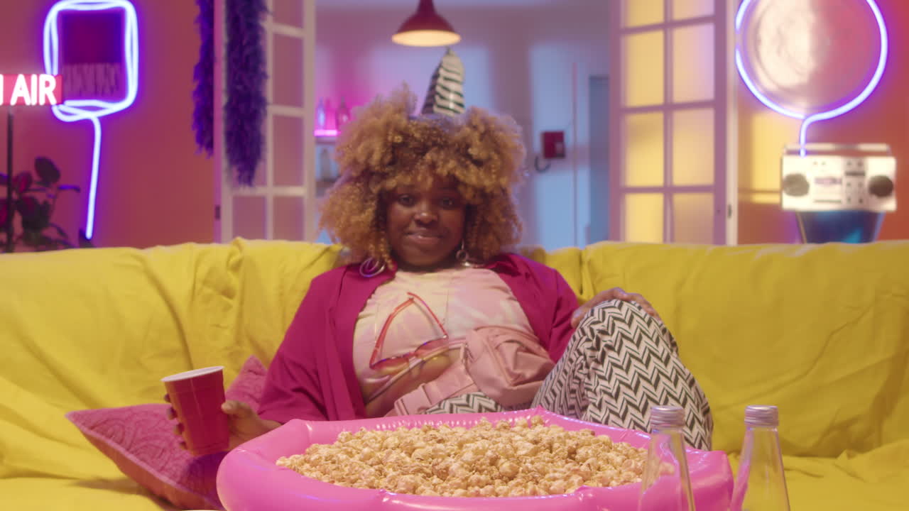 Woman Watching a Movie on a Cozy Retro Couch