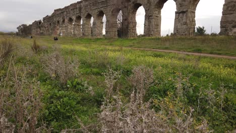 Detail-of-an-aqueduct-from-ancient-Rome-in-parco-degli-acquedotti-in-the-outskirts-of-the-capital-of-Italy,-tilt-up-reveal