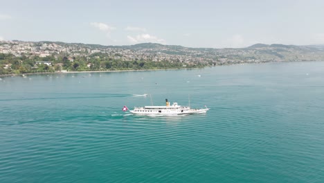 Wide-aerial-of-a-beautiful-steam-powered-cruise-ship-on-lake-Geneva,-Switzerland