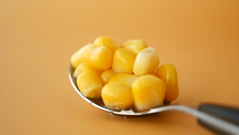 close up of a spoon full of corn kernels