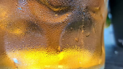 cold delicious beer inside wet glass, close up