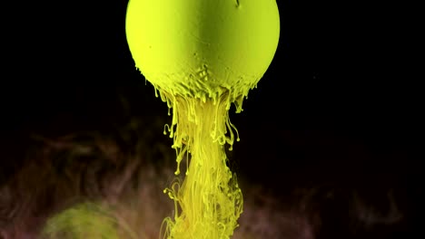 green ink paint slowly flows from the ball.