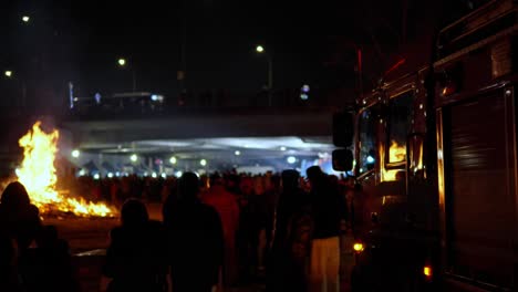 Crowd-Surround-Big-Buring-Fire-of-Daljip-Nori-on-Jeongwol-Daeboreum-Festival-Day-February-5-2023-at-Night-Ganganam-in-Seoul,-South-Korea