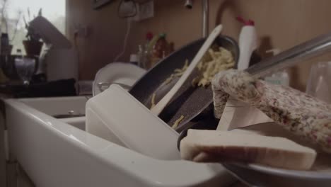 A-kitchen-is-full-of-dirty-dishes-in-a-bachelor's-apartment