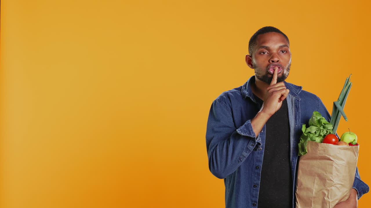 Young adult showing a hush silence symbol to keep secret
