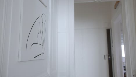 line painting of the female figure in an apartment hallway