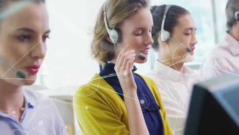 Animation-of-network-of-connections-over-office-workers-wearing-headsets