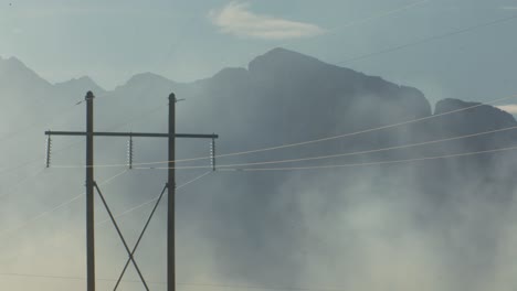 smoke from fire by the powerlines close up