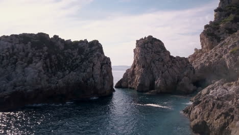 Smooth-drone-zoom-out-of-a-corner-of-Cala-Llonga,-Ibiza-Spain