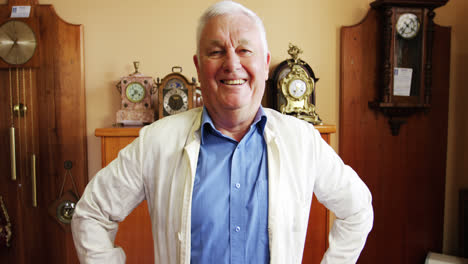 Portrait-of-smiling-horologist-standing-with-arms-crossed