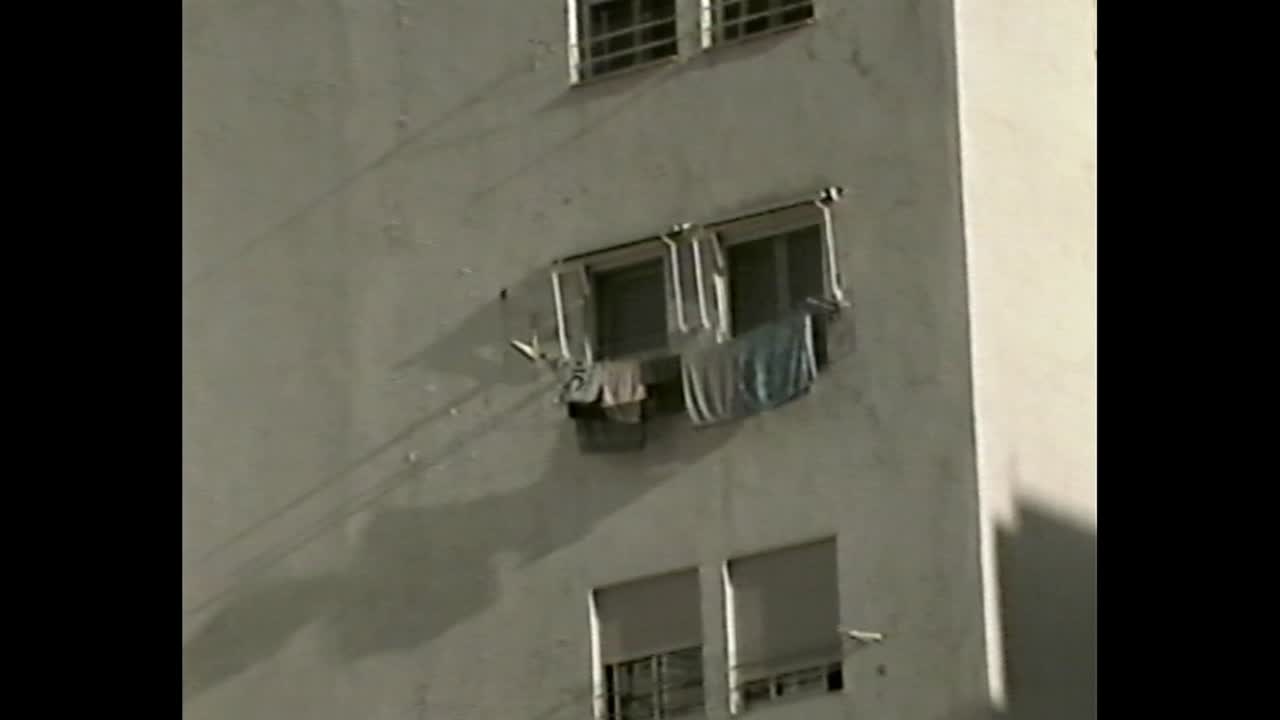 Residential buildings with white facades and closed blinds