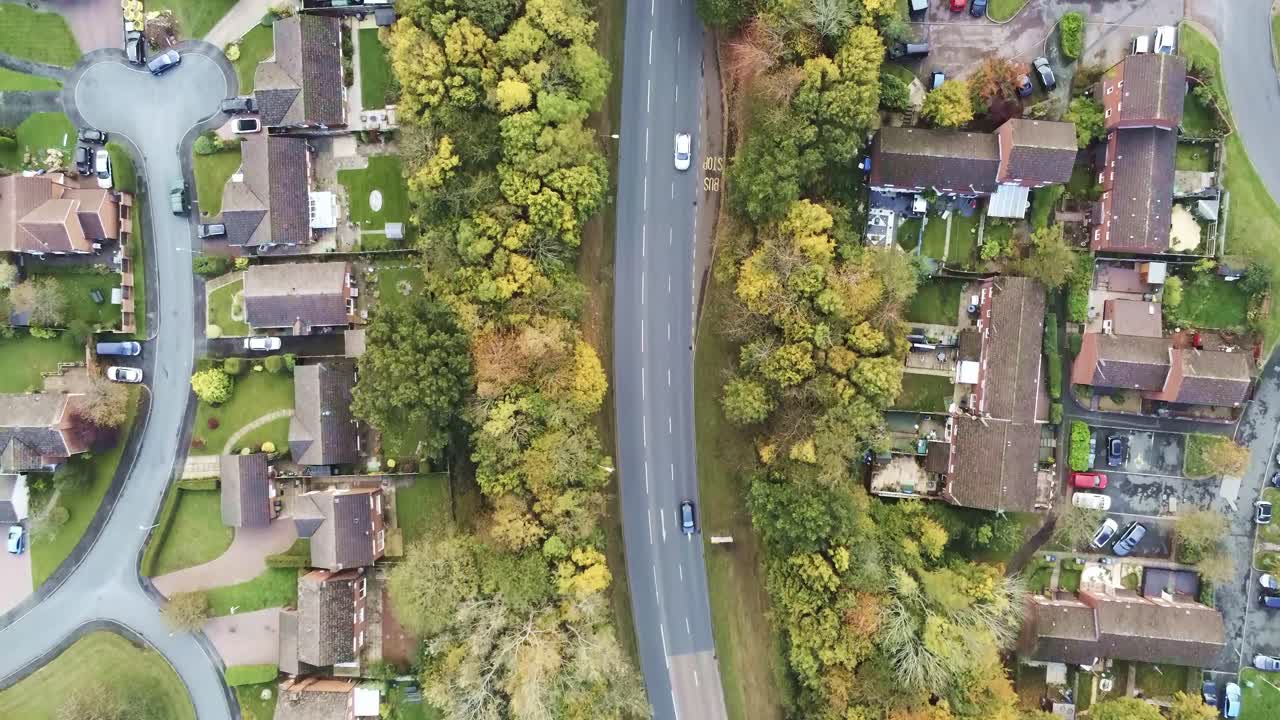 Suburb roads junction roundabout aerial view tracking traffic looking down