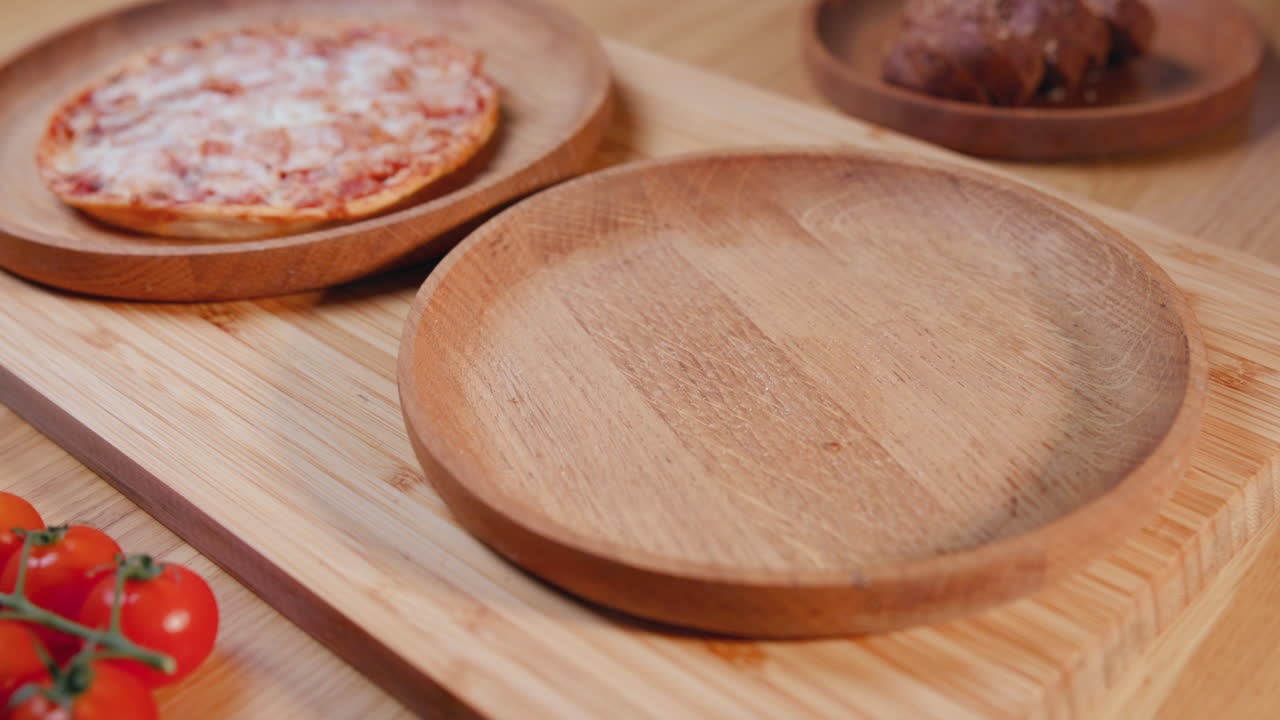 Several pizzas on wooden plates