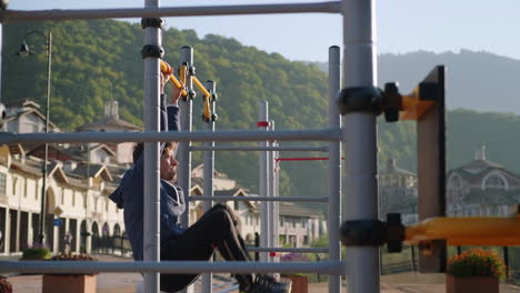 man doing pull-ups in outdoor fitness park