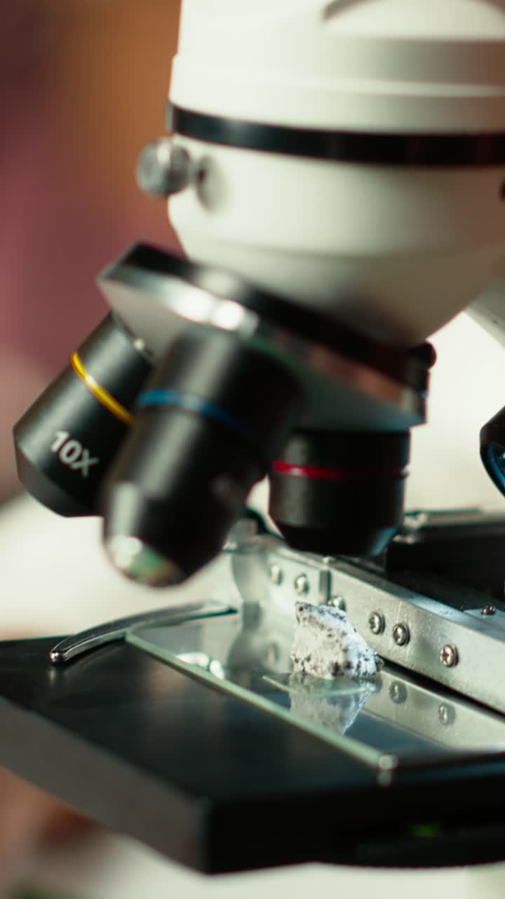 Close-up of Scientist Placing Sample on Microscope Slide