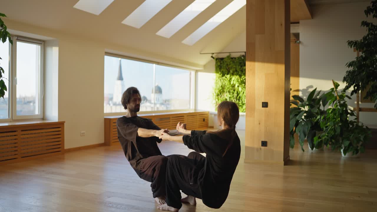 Couple practicing Tai Chi in a bright studio