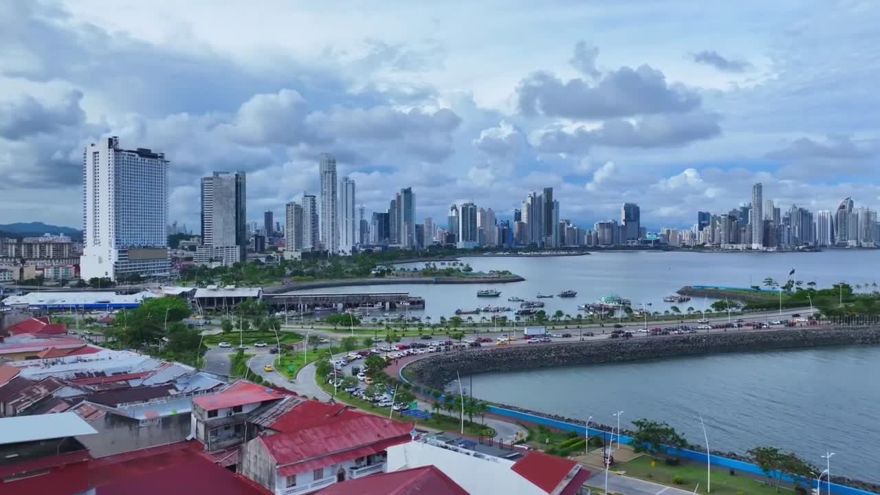 Panama city with clouds over the bay. Drone forward and left to right HD