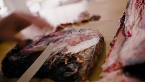 taking out the extra top layer from the steak with a small knife in a close-up view