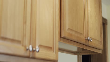 Rack-focus-shot-of-newly-remodeled-kitchen-cabinets-finished-in-light-wood