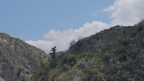 Time-lapse-of-clouds-moving-over-a-rocky-mountain-casting-their-shadows-on-the-hills-located-in-Echo-Mountain-Trails-California