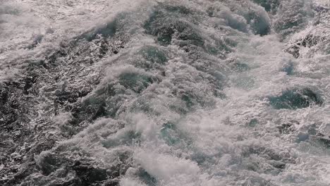 static close slow-motion shot from cruise ship for the ocean creating angry splashes