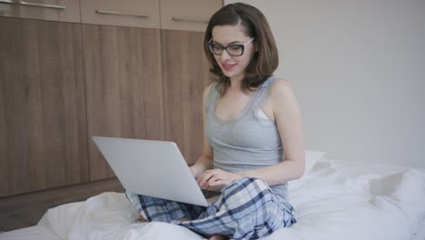 woman in glasses using laptop