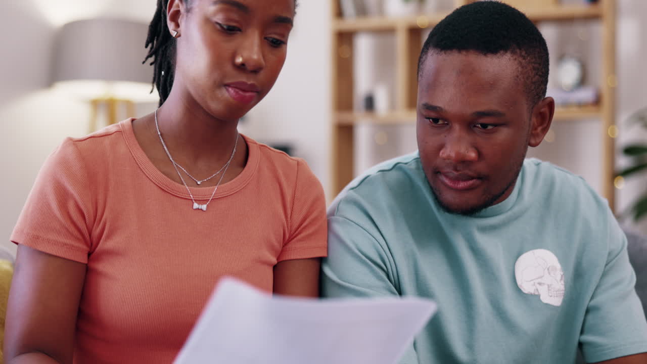 Budget, documents and couple in a living room