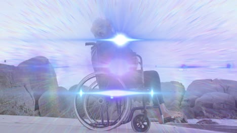 animation of light moving over smiling senior caucasian woman in wheelchair on beach looking to sea