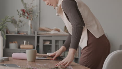 woman lighting candle with match