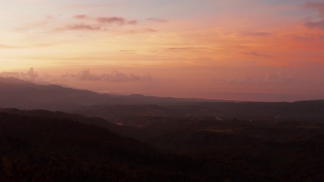 Golden-magical-aerial-landscape-drone-shot-at-sunset,-sunrise