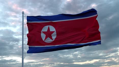 bandera realista de corea del norte ondeando en el viento contra el cielo profundo dramático. 4k uhd 60 fps cámara lenta