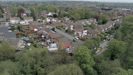 quiet british homes and gardens residential suburban property aerial view right orbit above trees