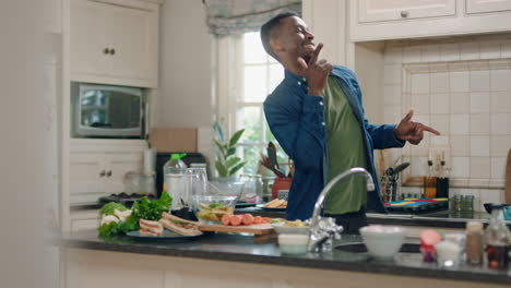 happy-african-american-man-dancing-in-kitchen-having-fun-dance-celebration-enjoying-weekend-at-home