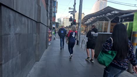 people walking near tram and scooter in melbourne